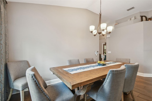 1187 Mistwood Dr, Tarpon Springs, FL 34688 - dining room with wood finished floors, baseboards, lofted ceiling, a notable chandelier, and visible vents