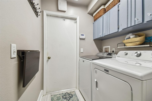1187 Mistwood Dr, Tarpon Springs, FL 34688 - washroom with light tile patterned floors, washing machine and clothes dryer, cabinet space, and baseboards