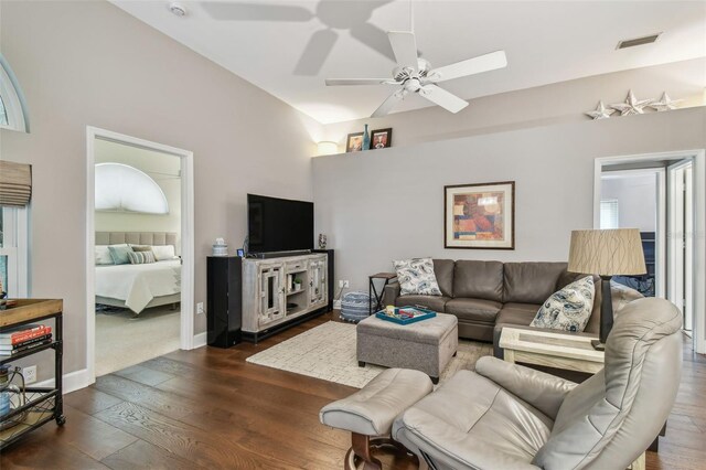 1187 Mistwood Dr, Tarpon Springs, FL 34688 - living room featuring lofted ceiling, ceiling fan, visible vents, baseboards, and dark wood-style flooring