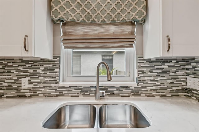 1187 Mistwood Dr, Tarpon Springs, FL 34688 - kitchen with tasteful backsplash, white cabinetry, and a sink