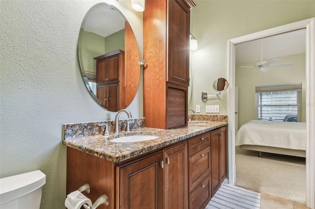 1187 Mistwood Dr, Tarpon Springs, FL 34688 - full bathroom with ceiling fan, toilet, a sink, and double vanity