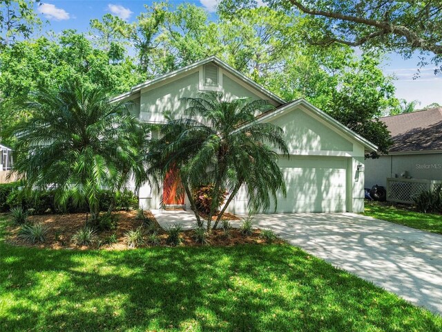 1187 Mistwood Dr, Tarpon Springs, FL 34688 - ranch-style home with an attached garage, a front lawn, and concrete driveway