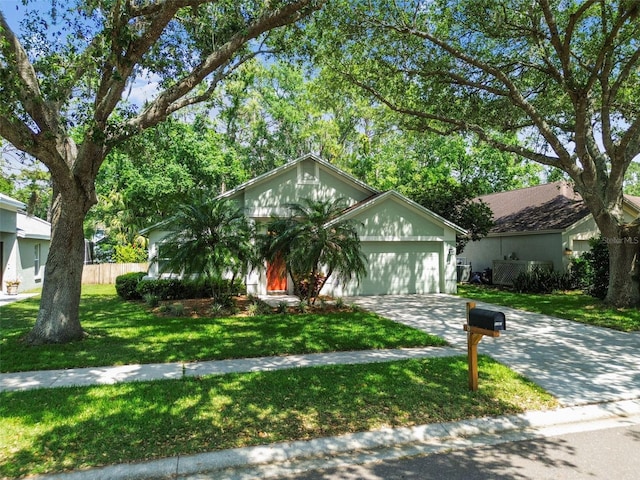 1187 Mistwood Dr, Tarpon Springs, FL 34688 - view of front facade with an attached garage, driveway, a front lawn, and fence