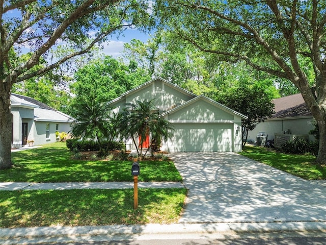 1187 Mistwood Dr, Tarpon Springs, FL 34688 - view of front of home with driveway, a front yard, and a garage