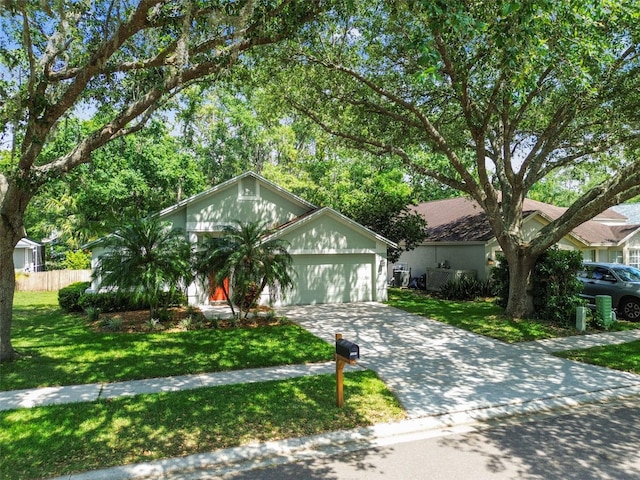 1187 Mistwood Dr, Tarpon Springs, FL 34688 - ranch-style house with an attached garage, driveway, fence, and a front yard