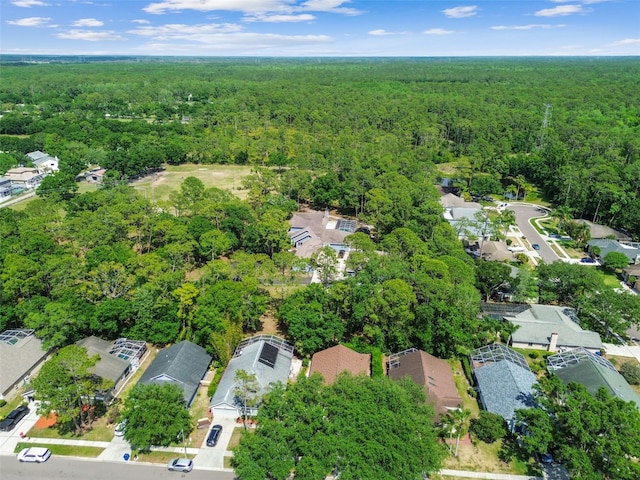 1187 Mistwood Dr, Tarpon Springs, FL 34688 - bird's eye view featuring a forest view and a residential view