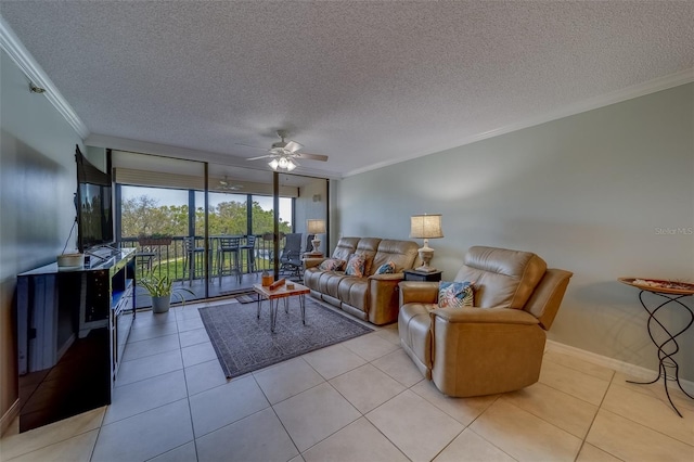 living area featuring crown molding, light tile patterned floors, baseboards, a textured ceiling, and a ceiling fan
