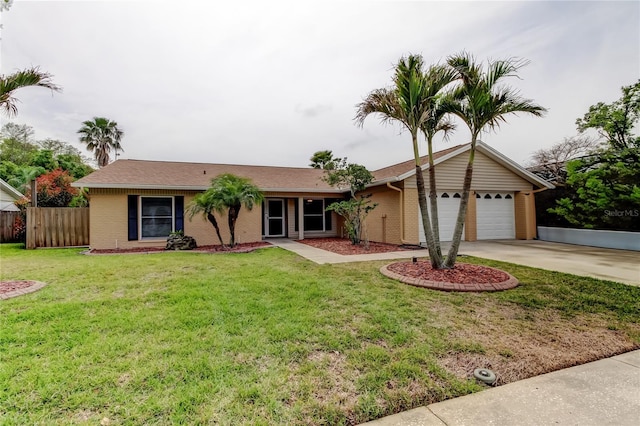 single story home featuring fence, an attached garage, concrete driveway, a front yard, and brick siding