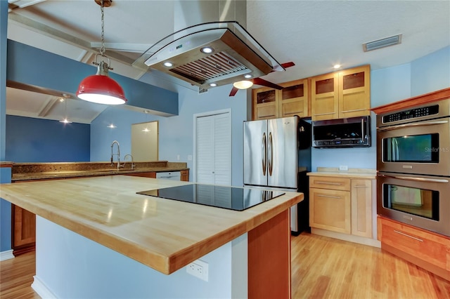 kitchen with visible vents, wood counters, and stainless steel appliances