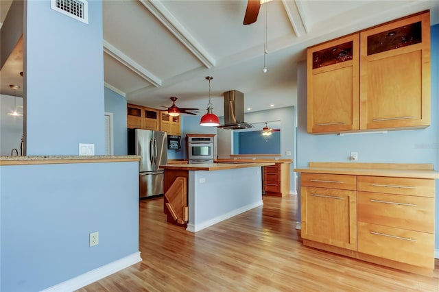 kitchen featuring light countertops, island range hood, a ceiling fan, and appliances with stainless steel finishes