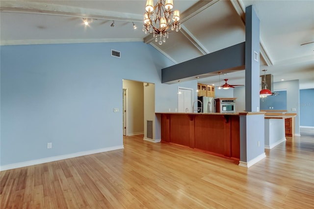 kitchen with open floor plan, stainless steel appliances, and light wood-style floors