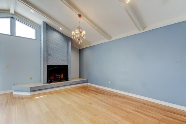 unfurnished living room featuring lofted ceiling with beams, baseboards, a fireplace, and wood finished floors