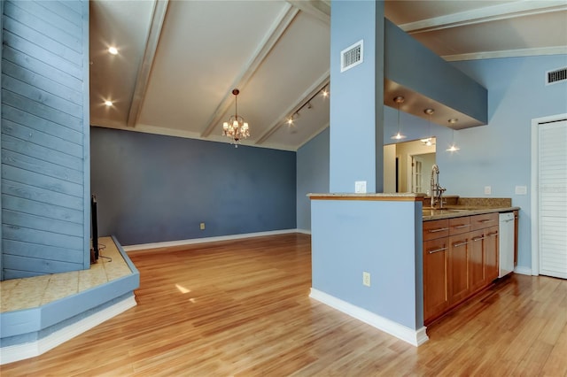 kitchen with light wood-style floors, vaulted ceiling with beams, visible vents, and brown cabinetry