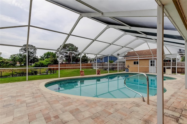view of pool featuring a patio, a fenced backyard, a fenced in pool, glass enclosure, and a lawn
