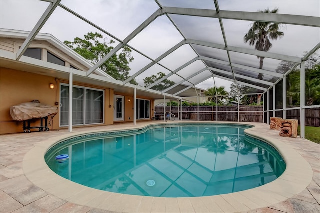 view of pool with a fenced in pool, a lanai, fence, and a patio