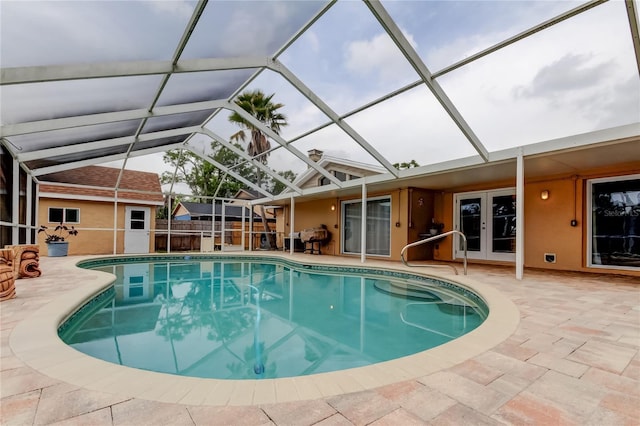 pool featuring french doors, a lanai, and a patio area