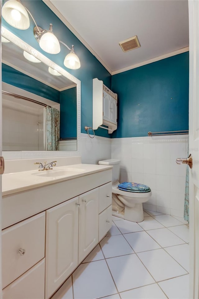 full bathroom with tile walls, a wainscoted wall, visible vents, vanity, and tile patterned flooring