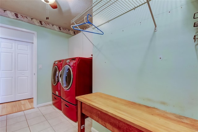 washroom featuring light tile patterned floors, washer and clothes dryer, and baseboards