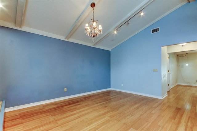 unfurnished room featuring visible vents, baseboards, wood finished floors, beam ceiling, and an inviting chandelier