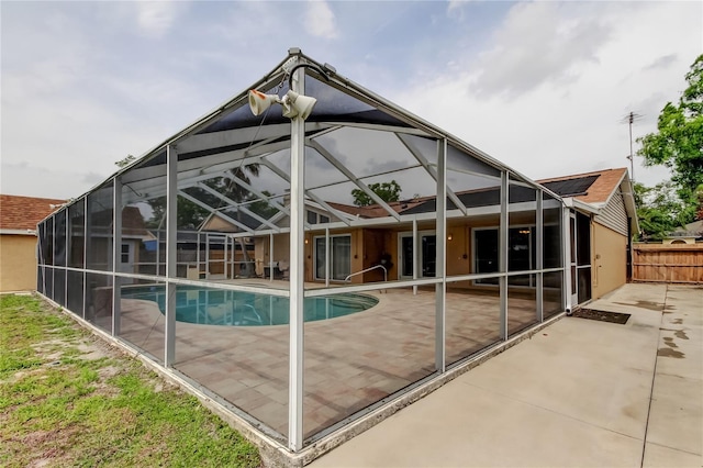 pool featuring fence, a lanai, and a patio area