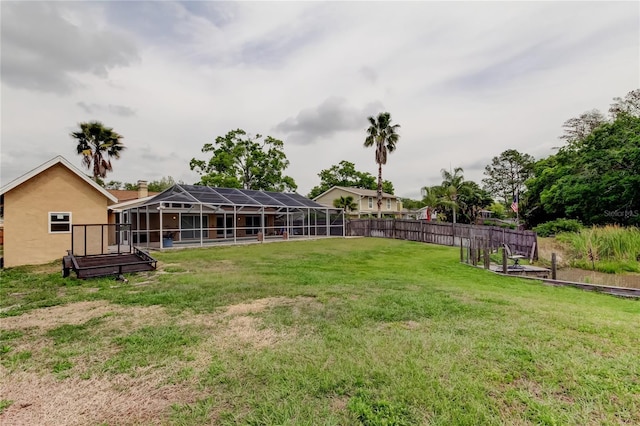 view of yard featuring fence and a lanai