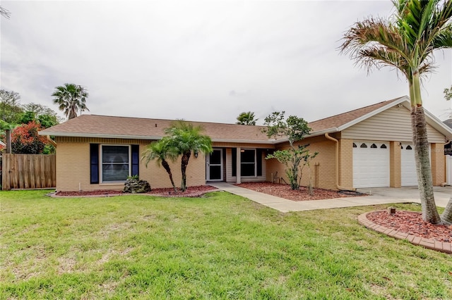 single story home featuring fence, an attached garage, brick siding, a front lawn, and driveway