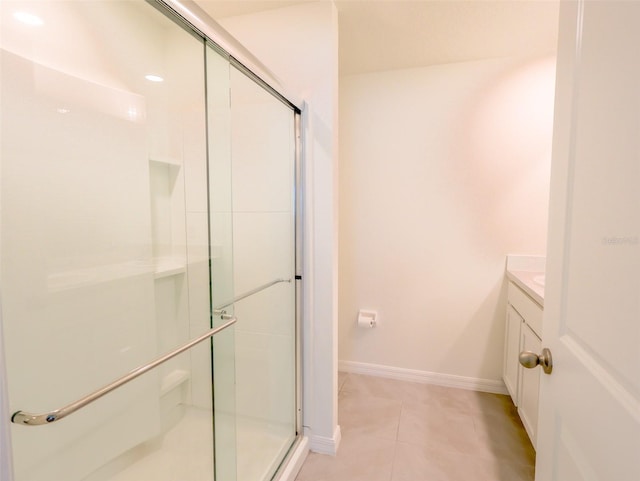 16805 Delia St, Wimauma, FL 33598 - bathroom featuring baseboards, vanity, tile patterned flooring, and a stall shower