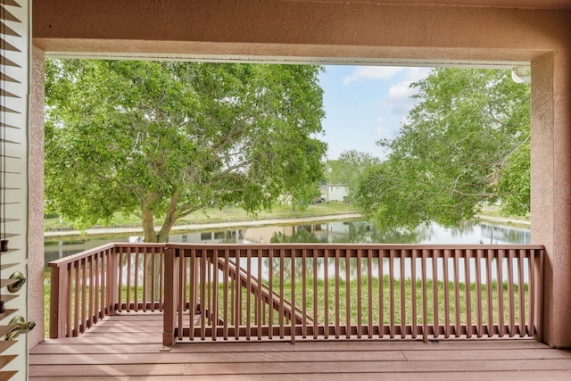 wooden deck featuring a water view