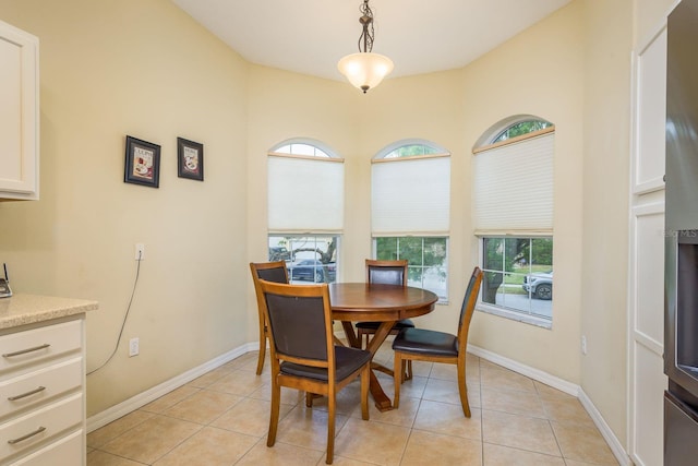 dining area with light tile patterned floors and baseboards
