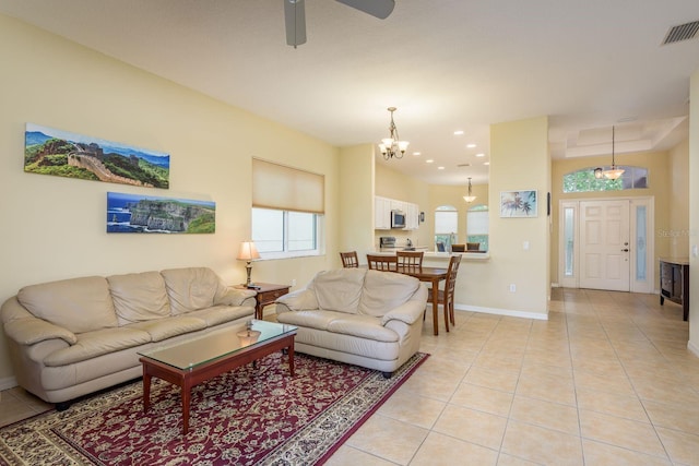 living area with ceiling fan with notable chandelier, visible vents, recessed lighting, light tile patterned flooring, and baseboards