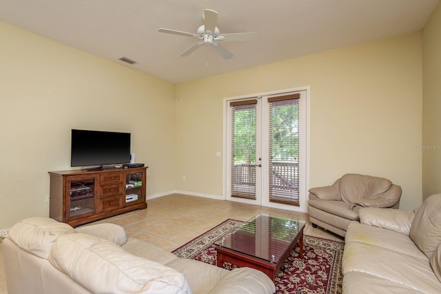 living room featuring ceiling fan, visible vents, light tile patterned flooring, french doors, and baseboards