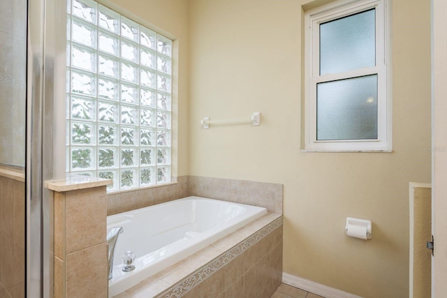 bathroom with tile patterned floors and a garden tub