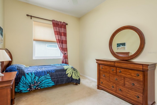 carpeted bedroom featuring ceiling fan and baseboards