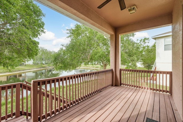 wooden deck with a ceiling fan and a water view