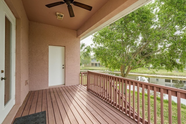 wooden terrace featuring a water view and ceiling fan