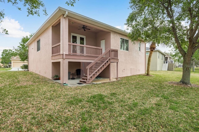 back of house featuring stucco siding, stairway, a patio area, ceiling fan, and a lawn