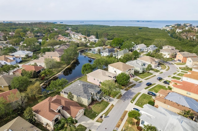 drone / aerial view with a residential view and a water view