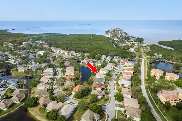 bird's eye view featuring a water view and a residential view