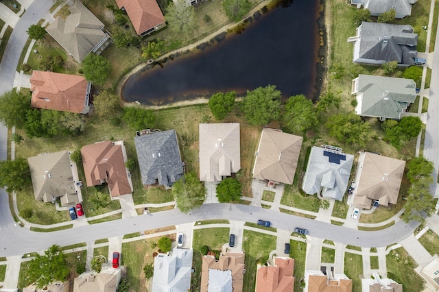 birds eye view of property with a water view and a residential view
