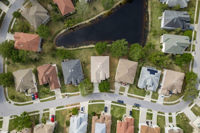 drone / aerial view featuring a water view and a residential view