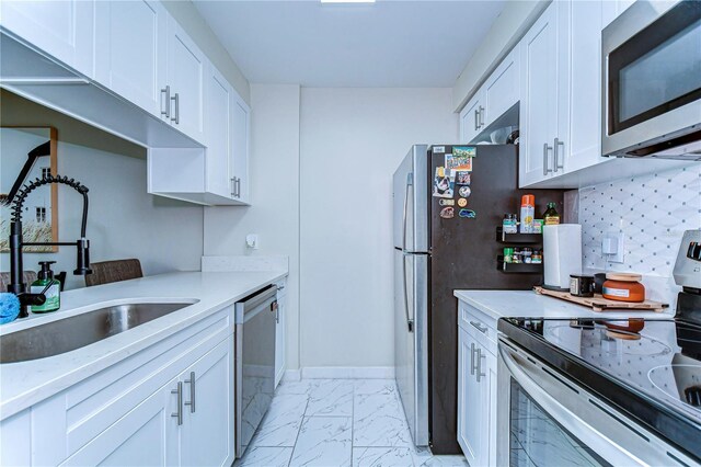 527 S Lincoln Ave Unit A108, Tampa, FL 33609 - kitchen with tasteful backsplash, stainless steel appliances, marble finish floor, a sink, and white cabinets
