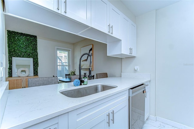 527 S Lincoln Ave Unit A108, Tampa, FL 33609 - kitchen featuring white cabinetry, marble finish floor, a sink, dishwashing machine, and light stone countertops