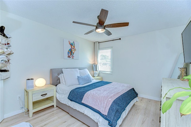 527 S Lincoln Ave Unit A108, Tampa, FL 33609 - bedroom with a ceiling fan, light wood-style flooring, baseboards, and a textured ceiling