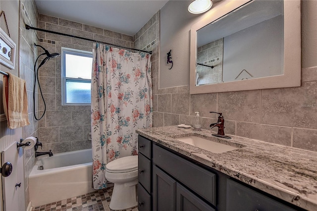 bathroom featuring toilet, vanity, tile walls, and shower / bath combo