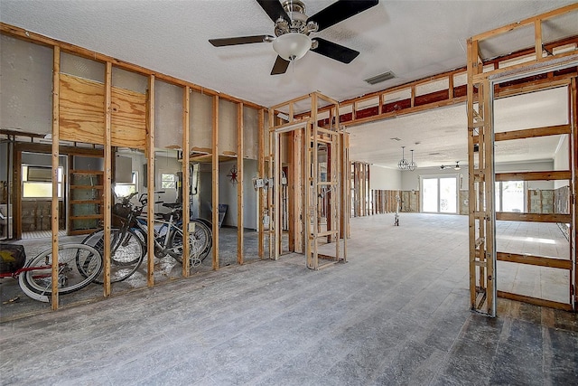 misc room with a textured ceiling, visible vents, and a ceiling fan