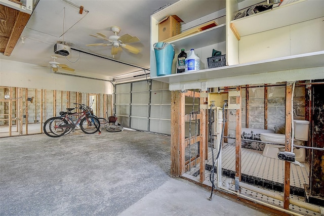 garage with ceiling fan and a garage door opener