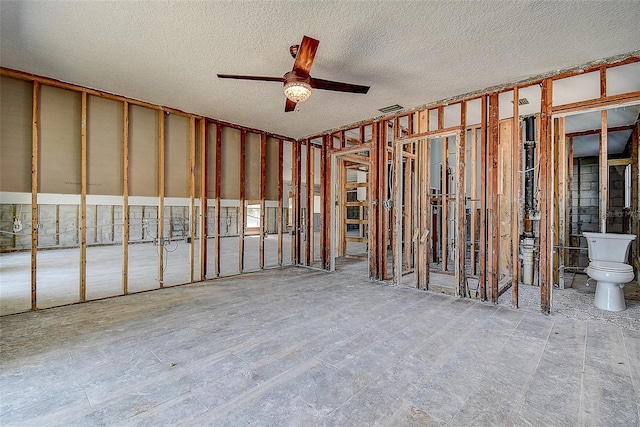 miscellaneous room with a textured ceiling, visible vents, and a ceiling fan