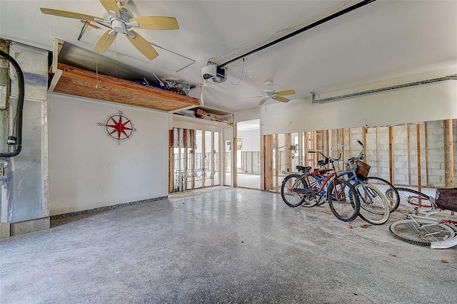 garage featuring ceiling fan and a garage door opener