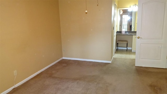 2101 Fox Chase Blvd Unit 102, Palm Harbor, FL 34683 - spare room with baseboards and carpet flooring