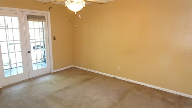 2101 Fox Chase Blvd Unit 102, Palm Harbor, FL 34683 - empty room with french doors, carpet floors, ceiling fan, and plenty of natural light